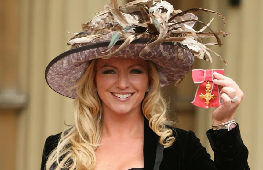 Photo: in 2010, Her Majesty the Queen awarded the Order of Lady Mont for outstanding contributions to business.  Source: michellemone.com
